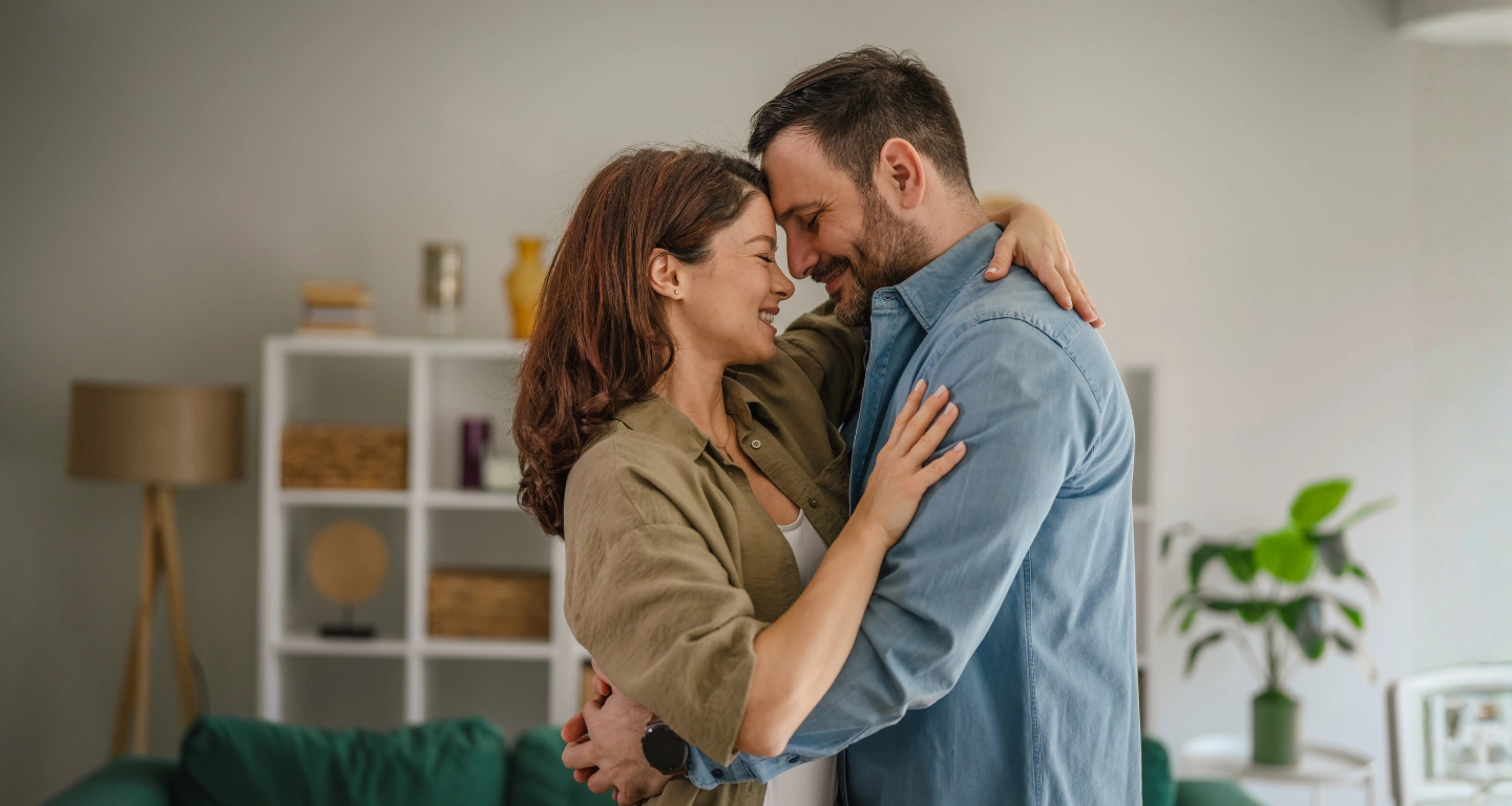 Two people connecting warmly over coffee
