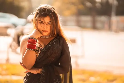 A woman photographed outdoors in warm sunset tones