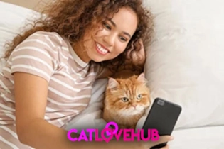 A person smiling while setting up a Cat Love Hub profile on a smartphone with her cat.
