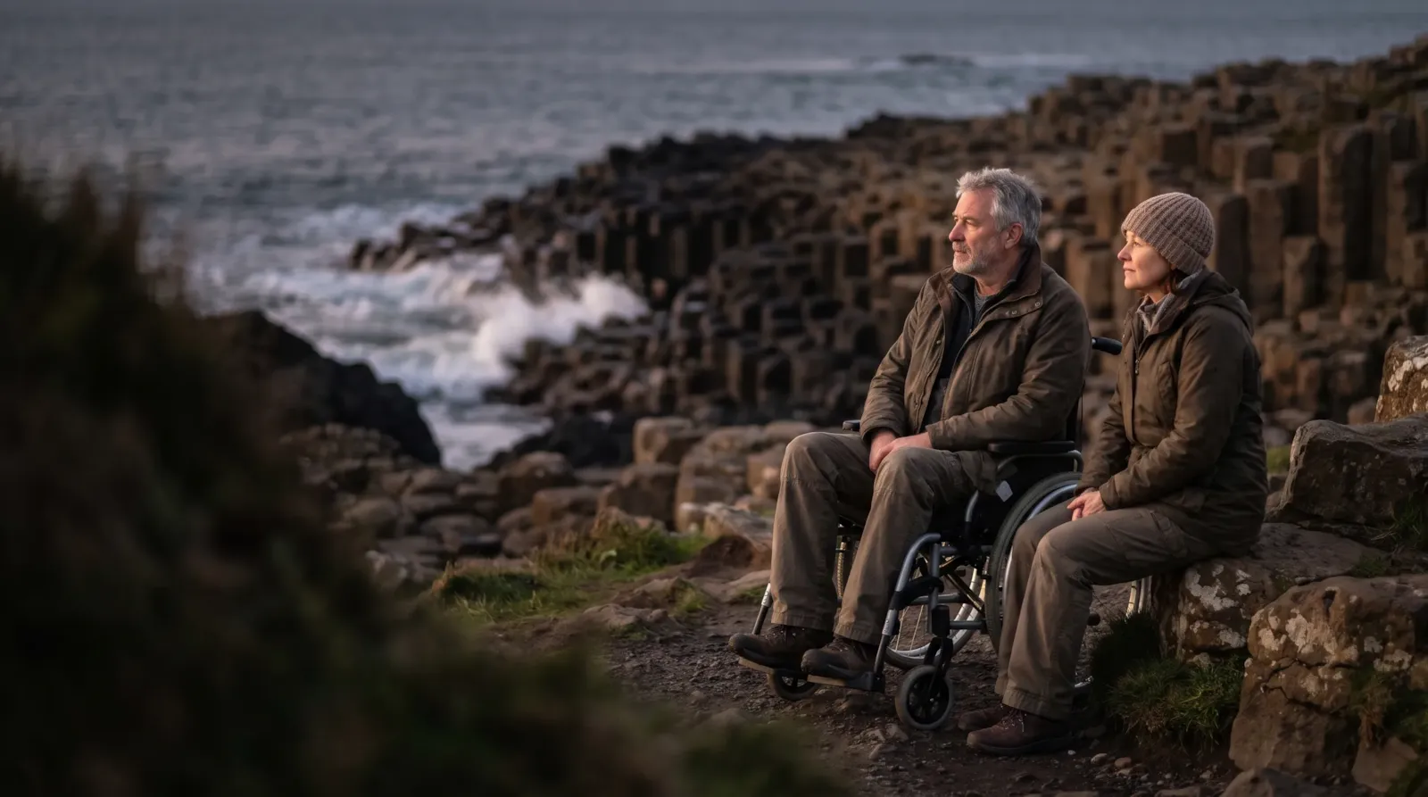 A couple on the Causeway Coast by the basalt columns; the man is a wheelchair user