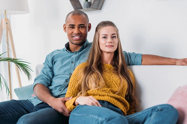 Loving interracial couple sharing a warm evening in their living room