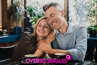 A mature couple cuddling up during a romantic first date at a local cafe.