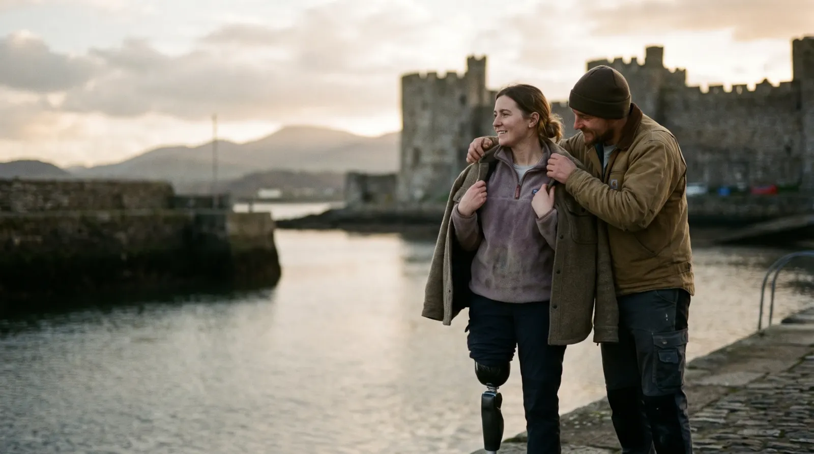 A couple on the Caernarfon waterfront below the castle; the woman has a prosthetic leg