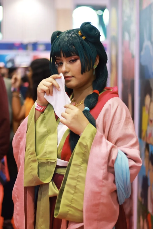 Illustrative photo of an anime-style cosplayer at a convention, not an actual member