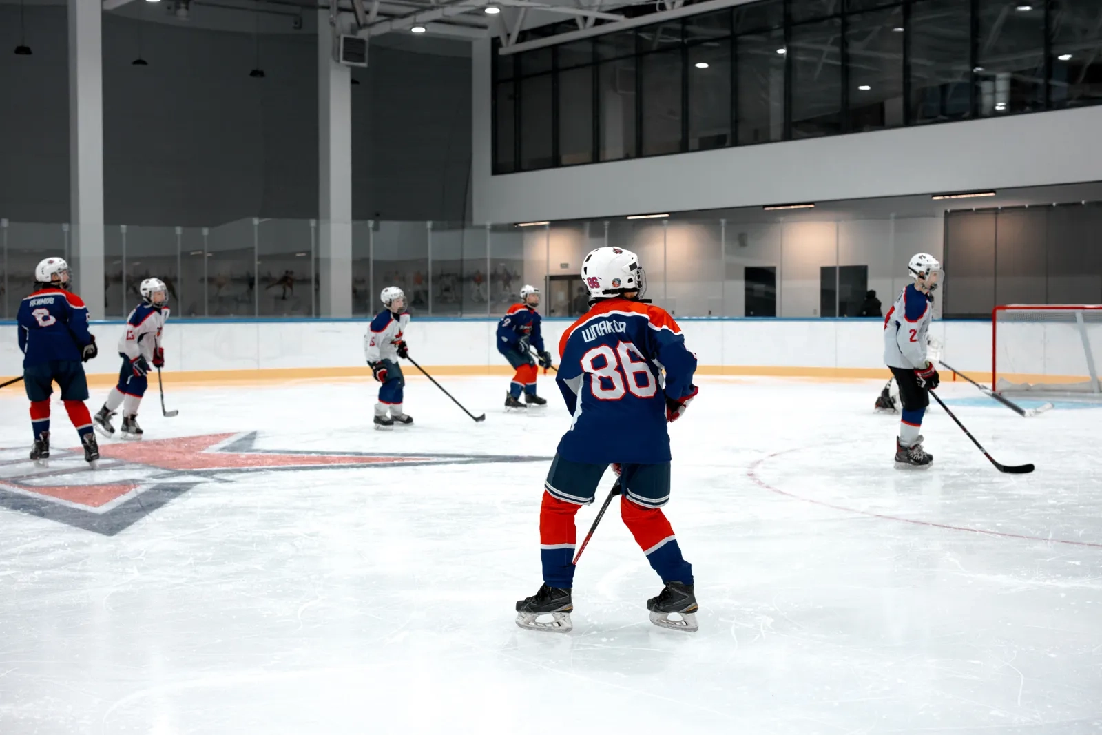Young players working through a drill on indoor ice
