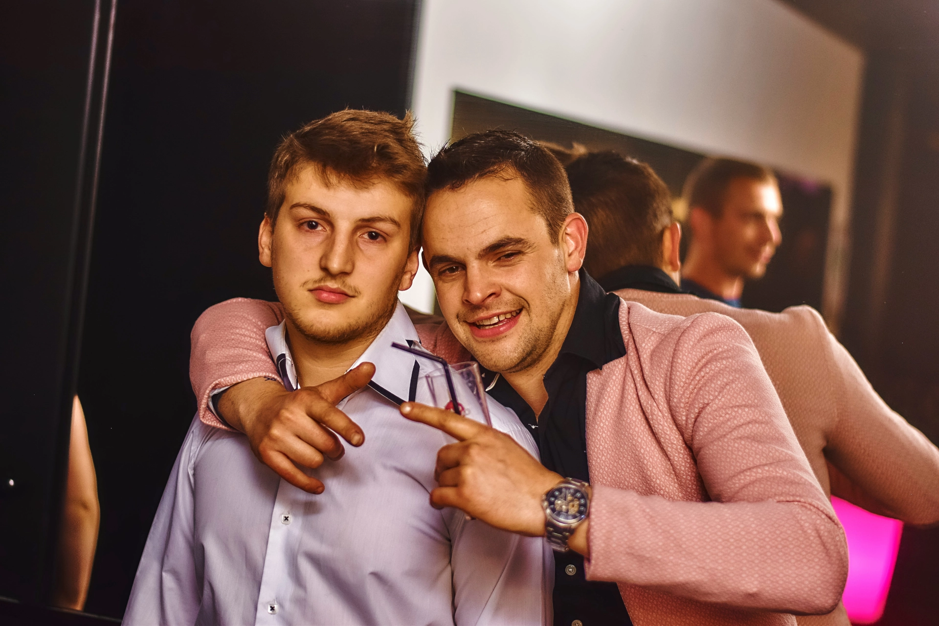 Dos hombres posando juntos en una fiesta.