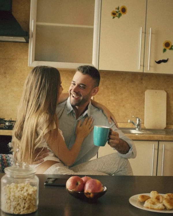 Couple chatting over coffee in a bright kitchen