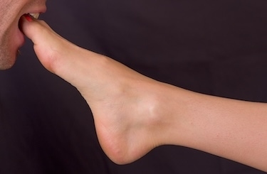 Consenting adults sharing a playful foot-focused moment