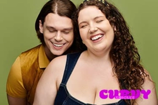 Happy curvy couple smiling on a romantic date