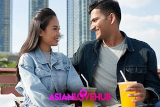 Happy Asian couple enjoying refreshments after meeting on Asian Love Hub dating app.