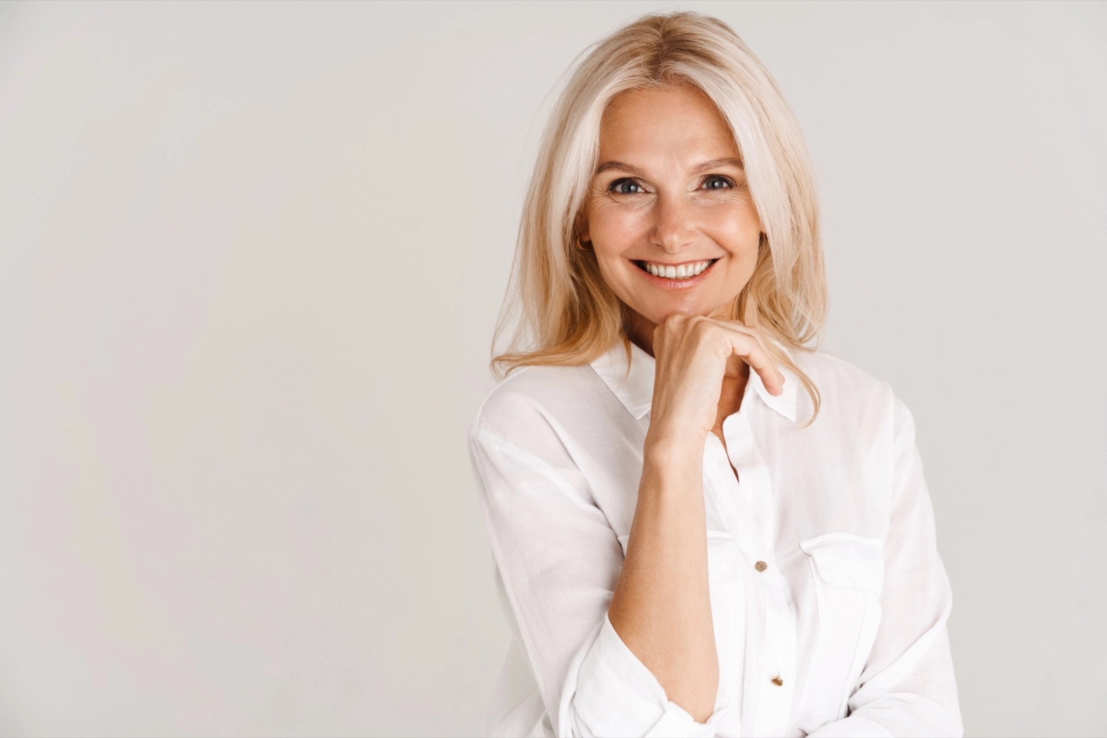 A genuine, smiling woman in her fifties