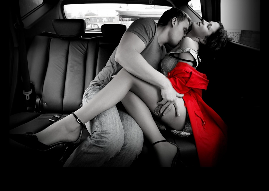 A car parked at a scenic lookout at dusk implying an outdoor date