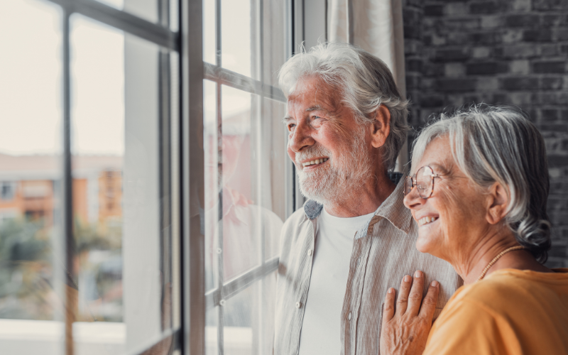 An older couple sitting together, relaxed and unhurried