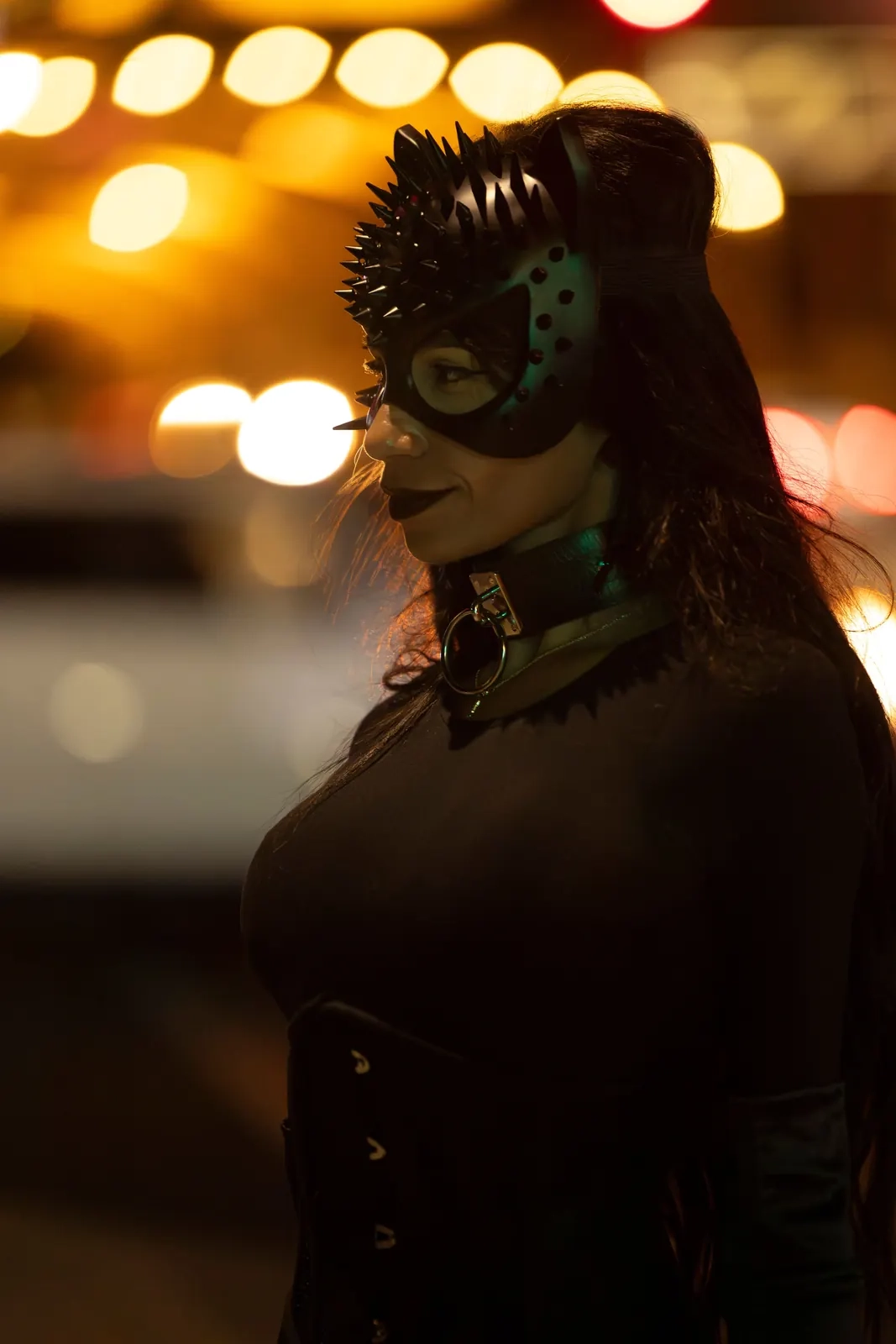 Illustrative stock portrait of a masked woman with city lights