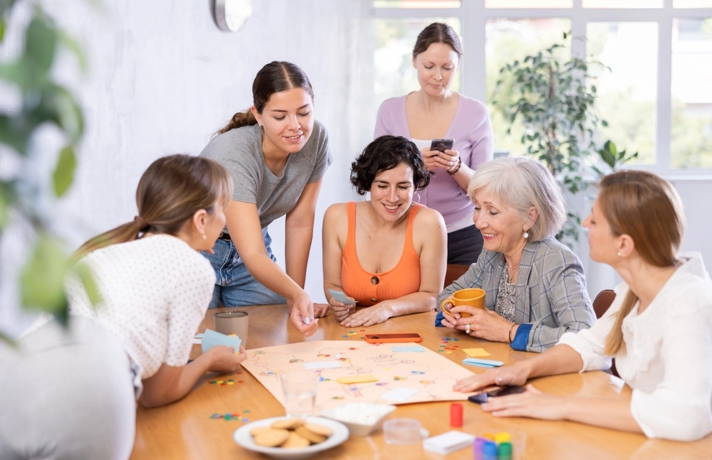 Women playing board games together at a meetup