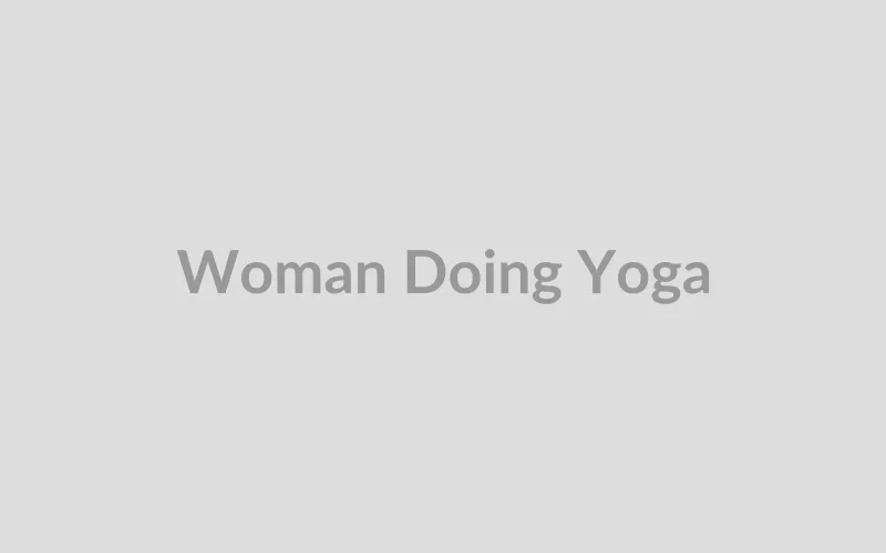 Fit woman practicing yoga pose outdoors at sunrise
