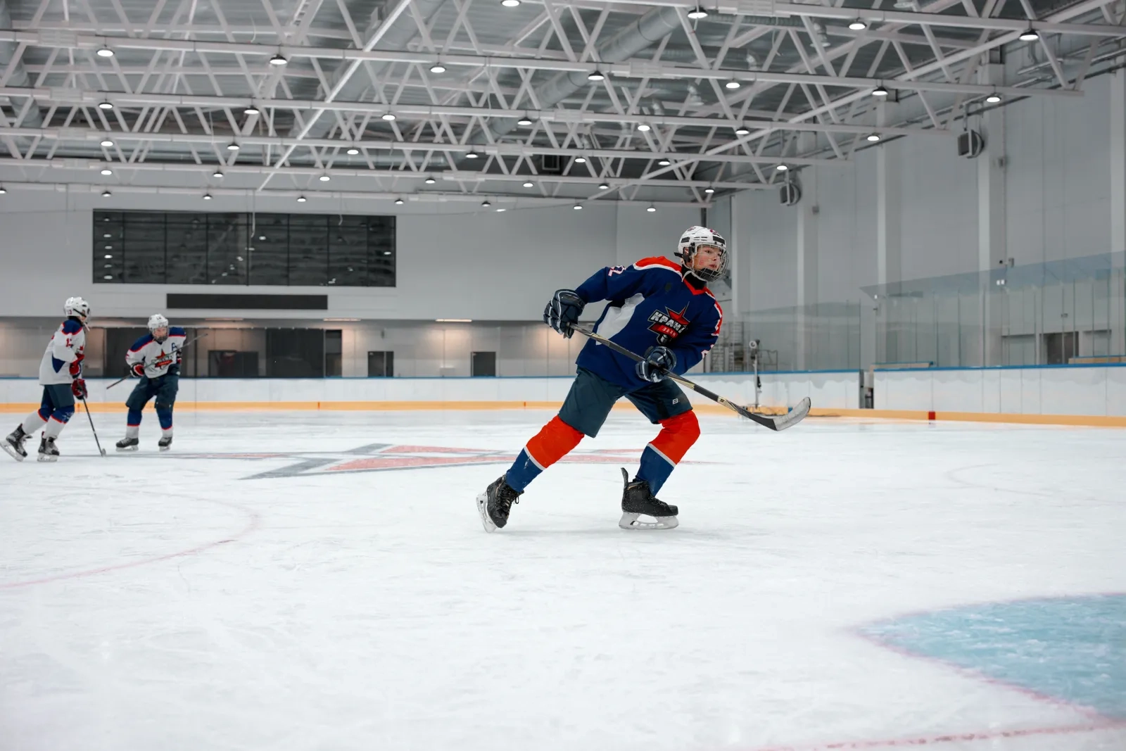 A skater moving the puck up ice at practice
