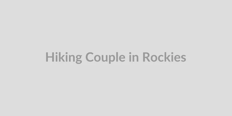 Fit couple hiking on a mountain trail with Colorado scenery