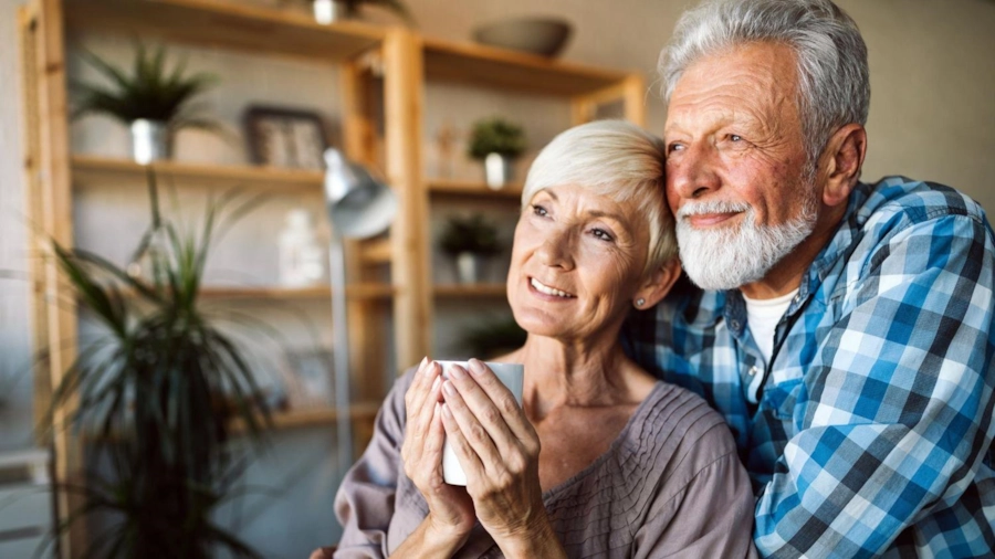 An older couple sharing a warm drink at home