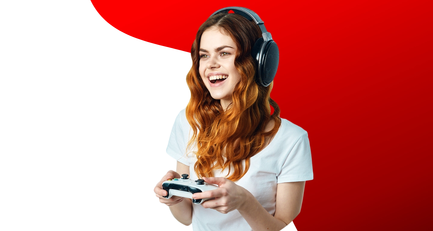 A laughing woman in a gaming headset holding a controller