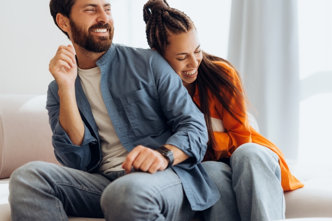 Couple laughing together, relaxed and at ease with each other