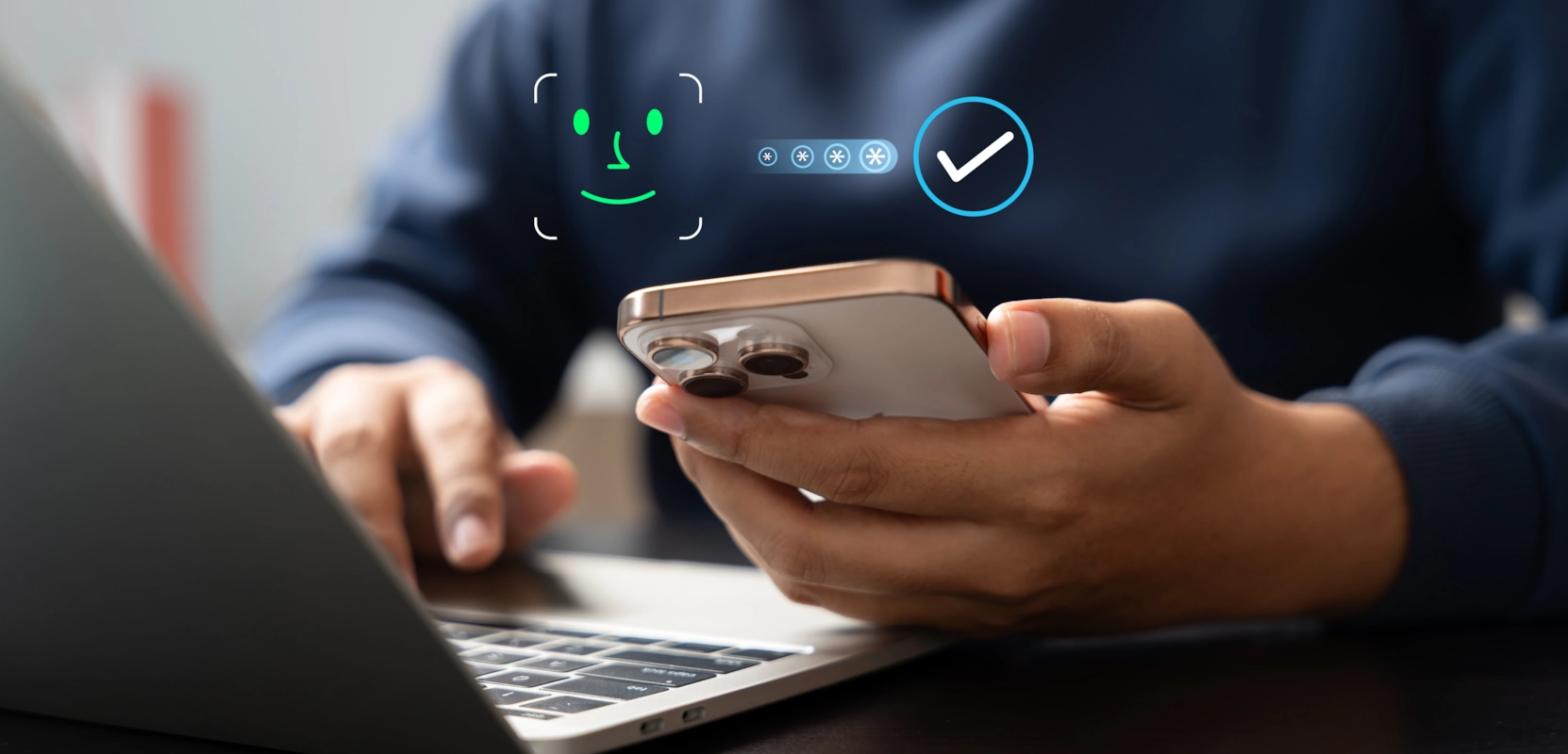 A person holding a smartphone with facial recognition and password verification icons overlaid, seated at an open laptop