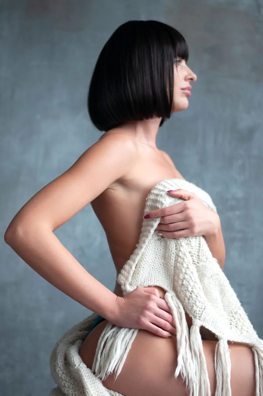 Adult woman posing with a cozy knit wrap