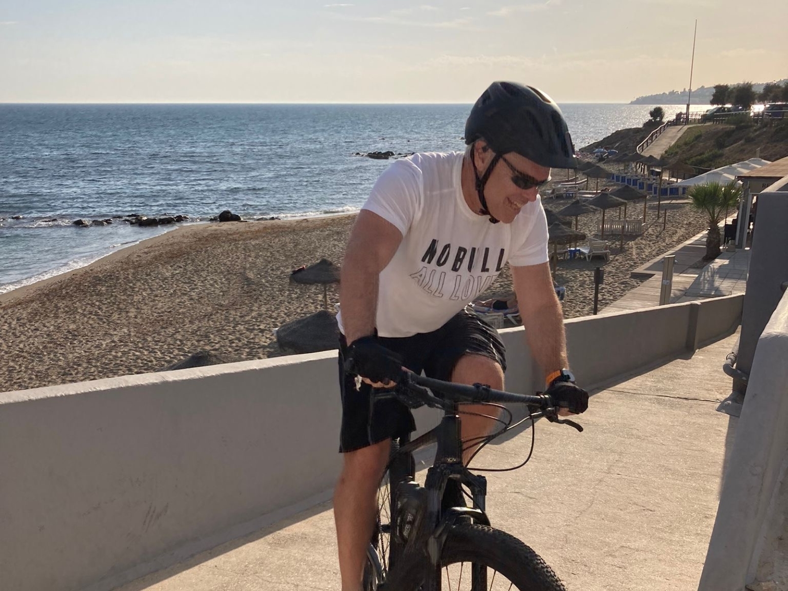Andy, founder of CyclingSingles.co, riding his mountain bike on the beach
